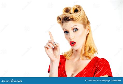 Portrait Of Beautiful Young Surprised Woman Dressed In Red Pin Up Dress Caucasian Blond Model