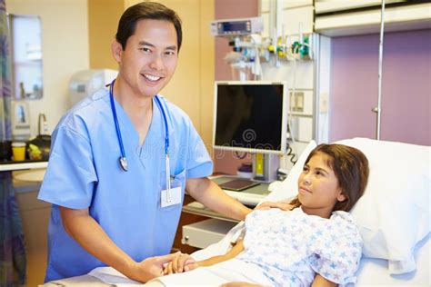 Young Girl Talking To Male Nurse In Hospital Room Stock Image Image