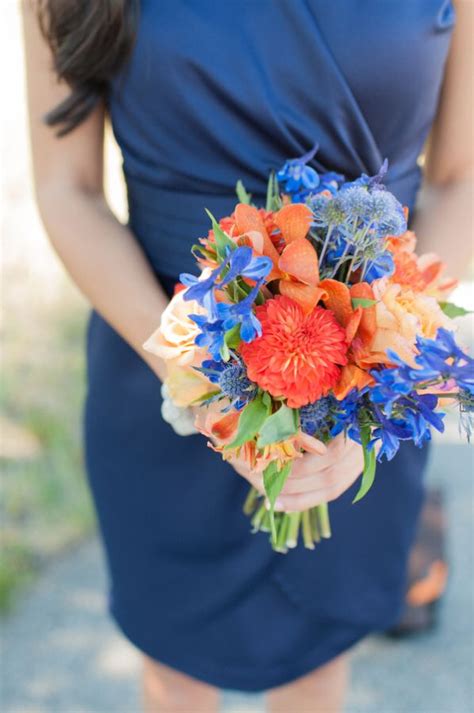 Orange, yellow, blue, and white bridal bouquet featuring roses, iris, and stock. These are perfect | Blue wedding bouquet, Orange wedding ...