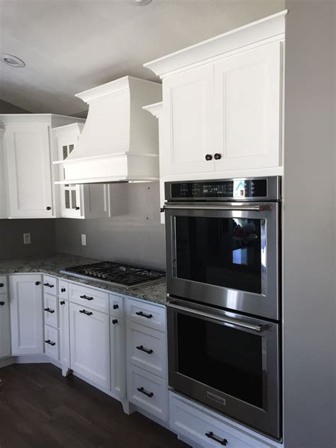 Plus, with their sealed burners and sleek finishes, cleanup is fast and easy. White kitchen cabinets with double oven, gas cooktop, and ...