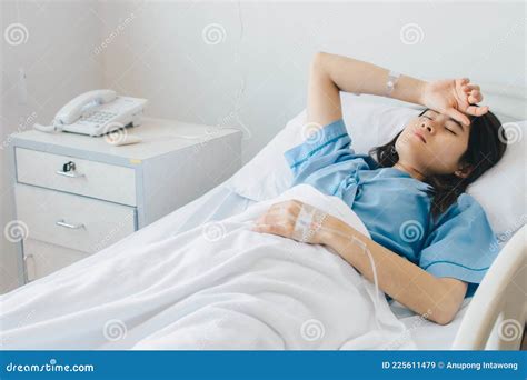 portrait of sickness patient woman lying on hospital bed resting for recovery stock image