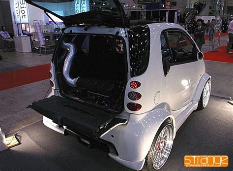 A Smart Car With Its Trunk Open On Display At An Auto Show In The City