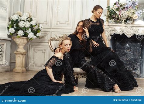 Three Young Pretty Lady In Black Lace Fashion Style Dress Posing In Rich Interior Of Royal Hotel