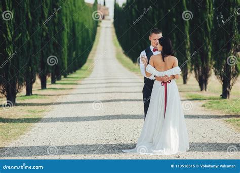 happy stylish smiling couple walking and kissing in tuscany ita stock image image of love