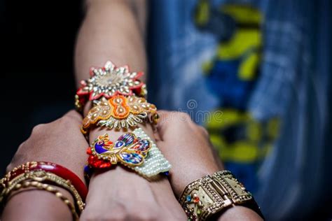Hand Of A Lady Tying Rakhi In Hand Of A Guy During The Hindu Ritual Of Rakshabandhan With