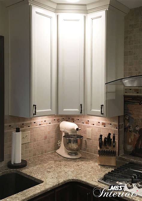 Sink base kitchen cabinet in satin white. A kitchen remodel in East Lansing, Michigan transformed the space from bland and bare to unique ...