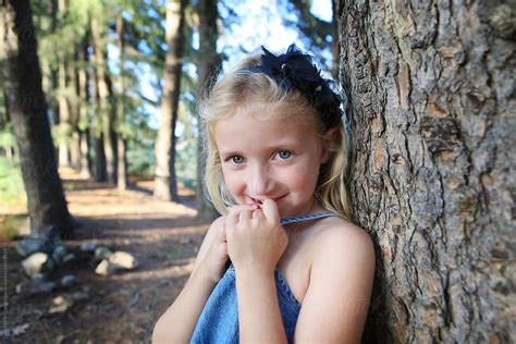 Little Blonde Girl In Forest With Blue Eyes By Stocksy Contributor