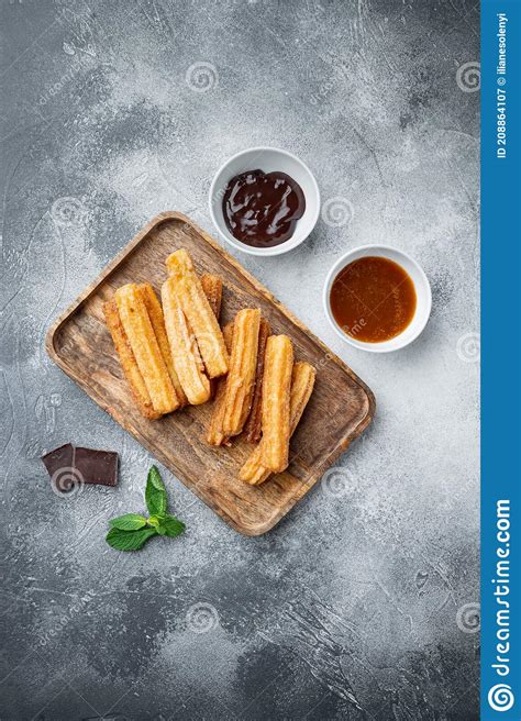 Tasty Churros With Chocolate Caramel Sauce On Gray Background Top View