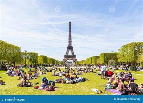 People On Champ De Mars With Eiffel Tower On Background Editorial