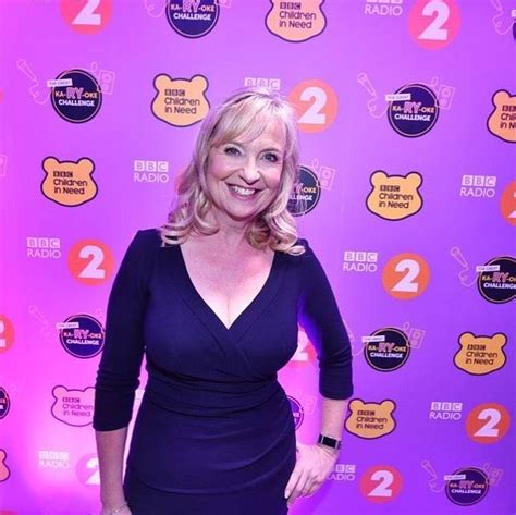 Carol Kirkwood Puts On Busty Display In Plunging Purple Dress