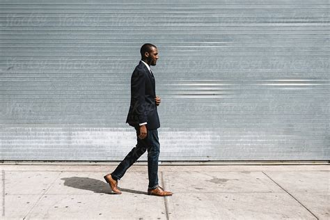 Black Businessman Walking In The Street By Stocksy Contributor