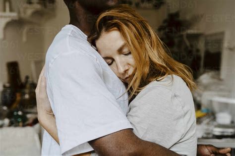 Son And Mother Embracing Each Other At Home Stock Photo