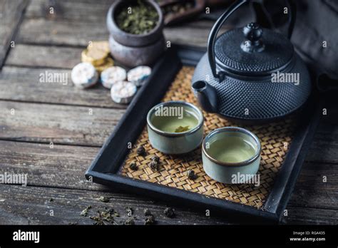Still Life Of Japanese Healthy Green Tea In A Small Cups And Teapot