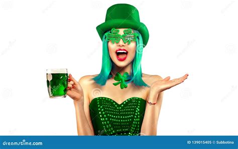 st patrick`s day leprechaun model girl with pint of green beer over white background patrick