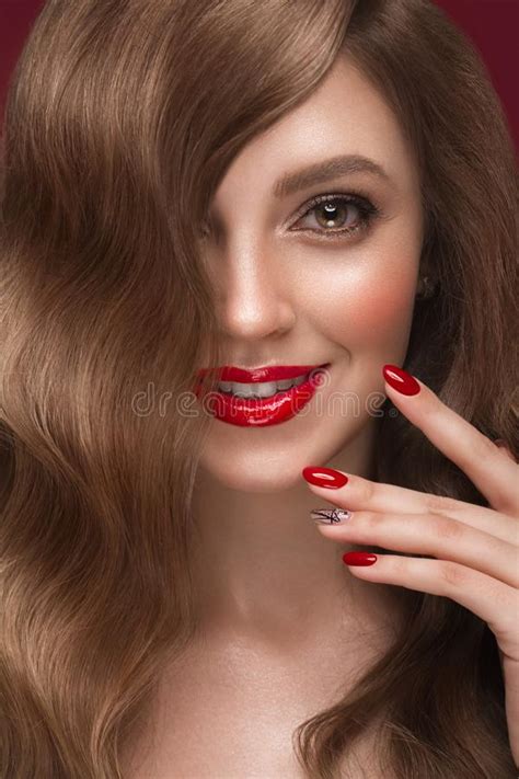 Beautiful Girl With A Classic Makeup Curls Hair And Red Nails