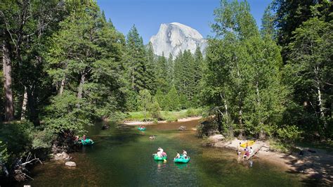 rafting down the merced river with a view of half dome in yosemite yosemite national park trips