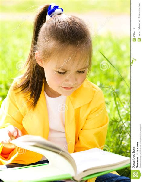 Little Girl Is Reading A Book Outdoors Stock Photo Image Of Bright