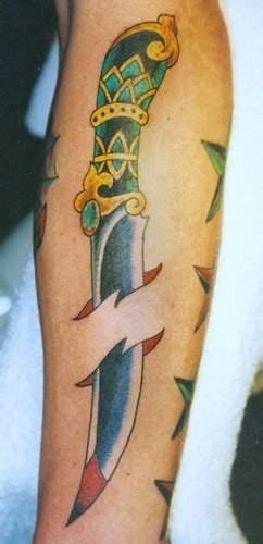 dagger pierced skin forearm tattoo tattooimages