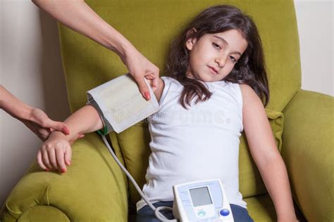 Doctor Checking Blood Pressure Of Small Beautiful Middle Eastern Girl
