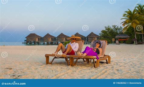 Couple Relaxing On The Sandy Beach In Maldives Stock Photo Image Of Chair Adult
