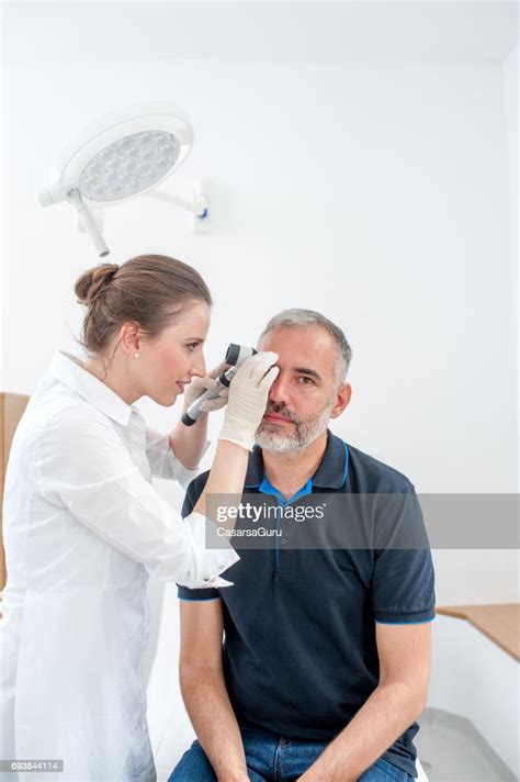 Dermatologist Inspecting Skin Moles On Patient Face High Res Stock