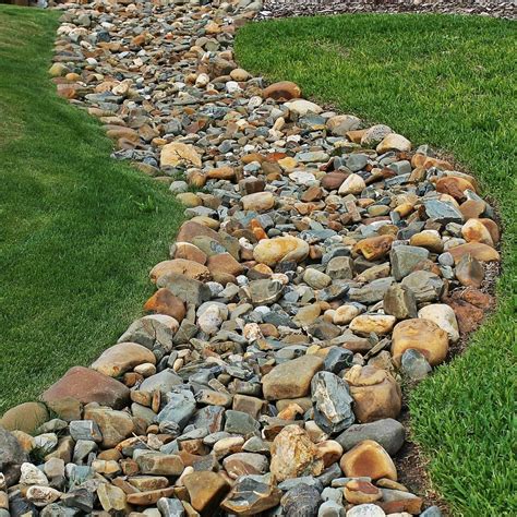 While several sizes and types of gravel may be used for the drain, your best option may depend upon the slope of the yard and whether you use a perforated pipe to help whisk the water away. dry creek bed landscaping - Google Search | River rock ...