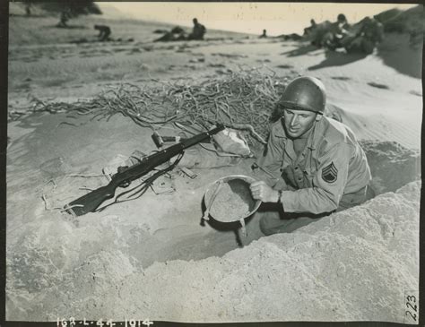 Us Soldier Digging Foxhole With Helmet During Training Exercises At San