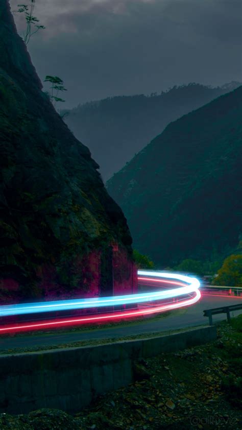 Long Exposure Photograph Of Light Streaks On The Road In Front Of A