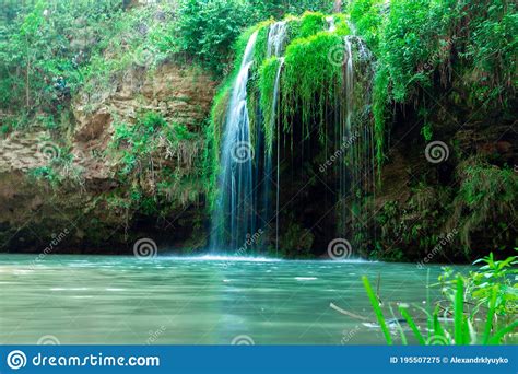 Jungle Landscape With Flowing Turquoise Water Of A Cascading Waterfall