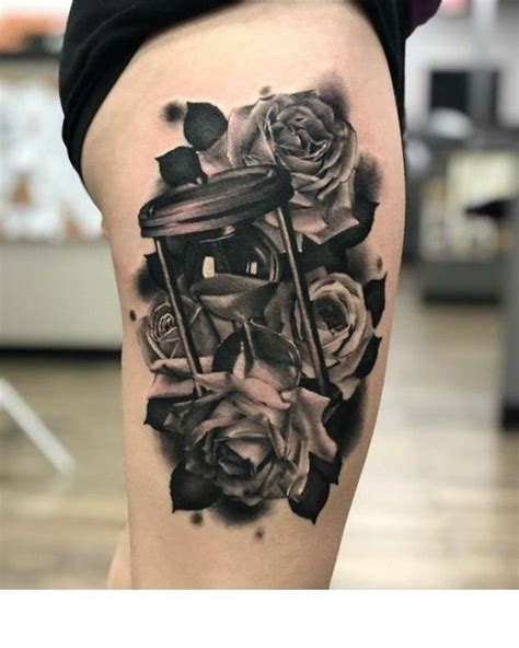 A Womans Thigh With Roses And An Hourglass Tattoo On Her Left Leg