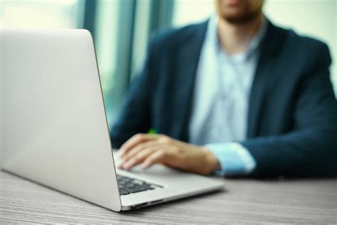 Young Man Working With Laptop Mans Hands On Notebook Computer