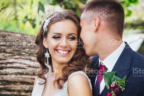 Beautiful Wedding Couple In Park Bride And Groom Kissing And Hugging