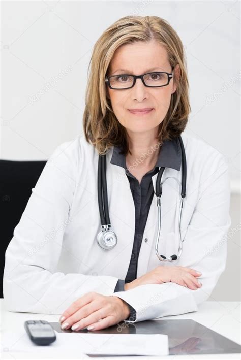 female doctor sitting at her desk female doctor female doctor