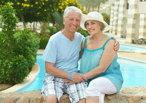 Premium Photo Senior Couple By Pool At The Resort During Vacation