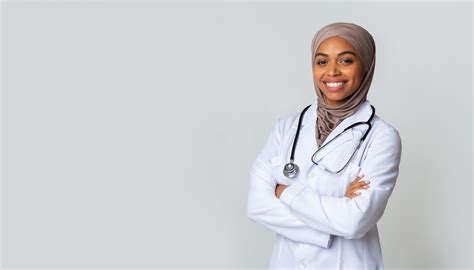 Portrait Of Smiling Black Female Doctor In Hijab And White Coat Linguava