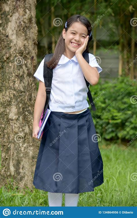 Smiling Catholic Girl Student Wearing Uniform With Notebooks Stock