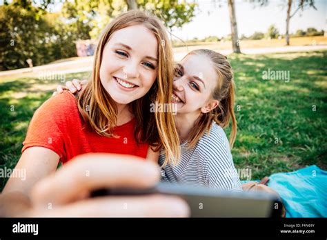Two Happy Teenage Girls Taking A Selfie On Meadow Stock Photo Alamy