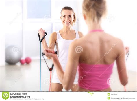 Category all abs beauty muscle biceps calves & legs celebrities female bodybuilders fitness & figure women models sports women strong women videos. Two Young Women Exercise The Back Muscles Stock Photo ...