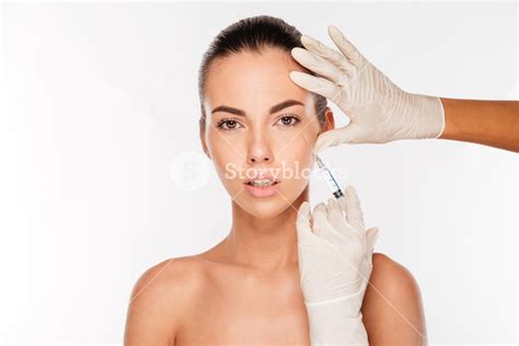 Beautiful Woman Gets An Injection In Her Face Isolated On White