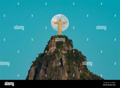 Christ The Redeemer Statue On Top Of The Corcovado Mountain And The