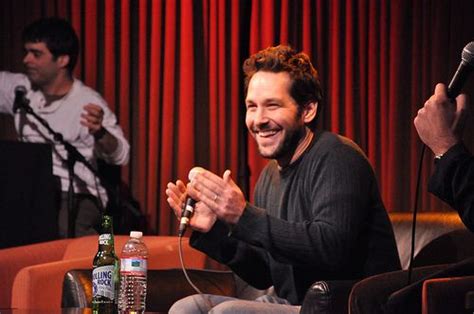 Paul Rudd Clapping His Hands While Holding A Microphone He Looks