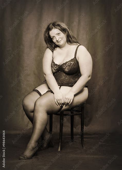 Overweight Woman Dressed In Corset And Folding Fan Black And White