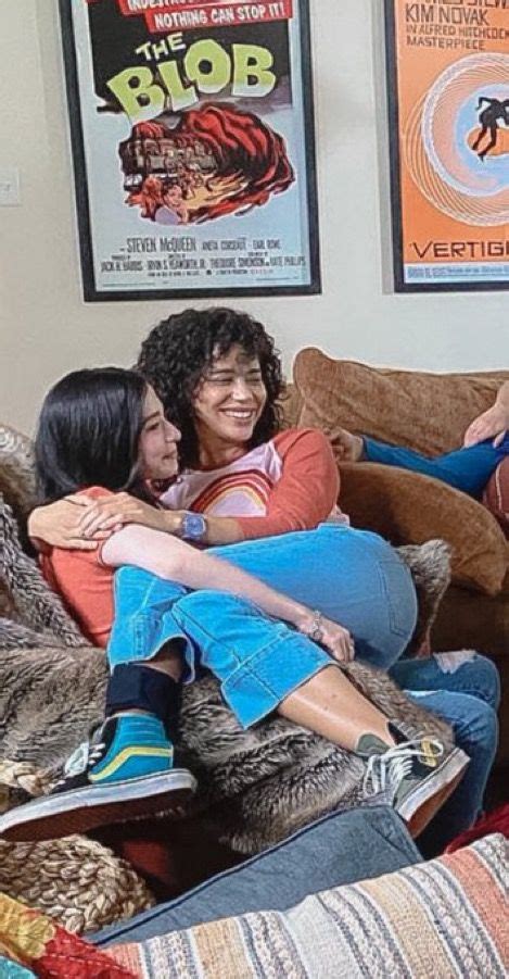 Three Women Sitting On A Couch With Their Arms Around Each Other