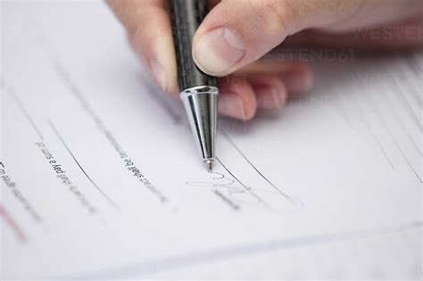 Woman Signing Documents Stock Photo