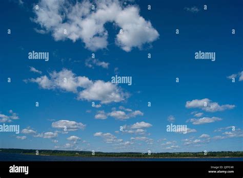 The Horizontal Photo Is A Blue Sky With White Fluffy Clouds Background
