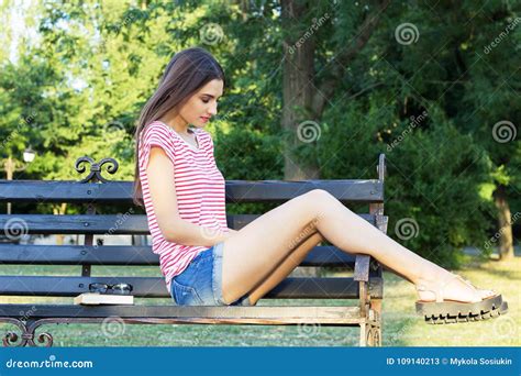 Sad Thoughtful Young Girl Sitting Alone On A Bench Outdoors Pretty