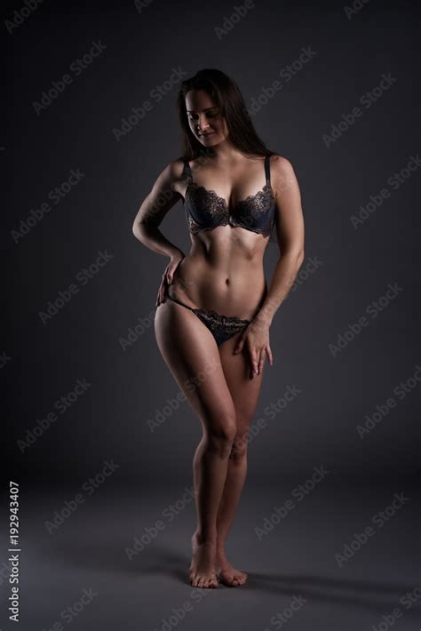Beautiful Sexy Woman In Lingerie Posing On Gray Studio Background