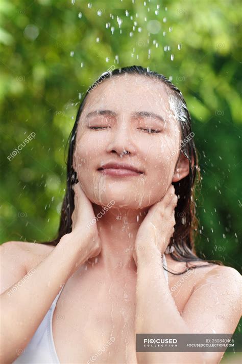 Close Up View Of Beautiful Young Asian Woman Taking Shower With Closed