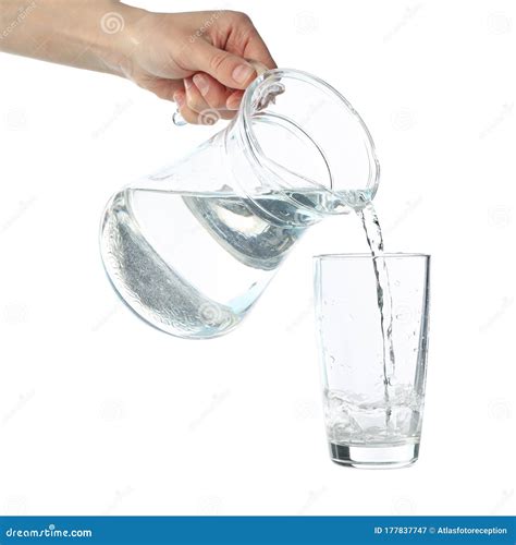 Pouring Purified Fresh Water From The Jug In Glass Isolated On