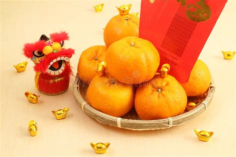 Mandarin Oranges In Basket With Chinese New Year Red Packets And Lion